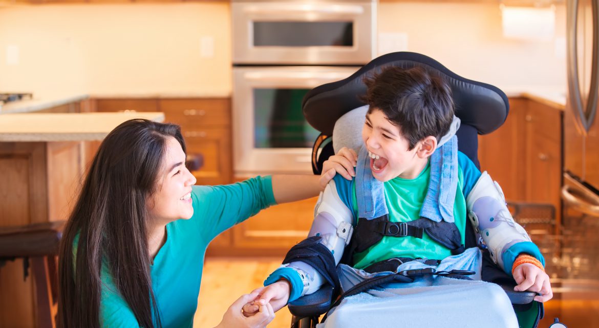 Child in wheelchair with caregiver